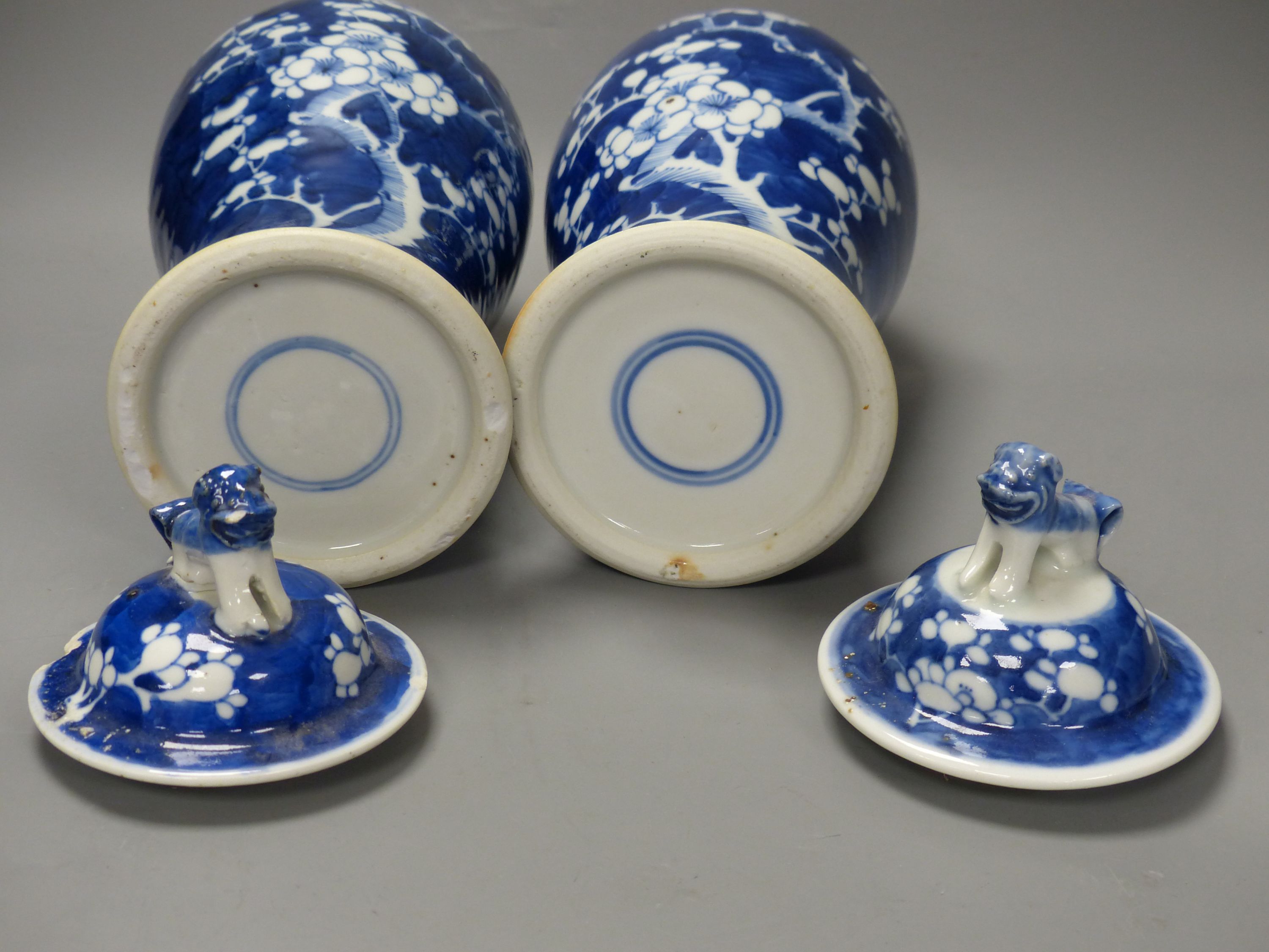 A pair of Chinese blue and white prunus vases and covers, early 20th century, overall height 35cm